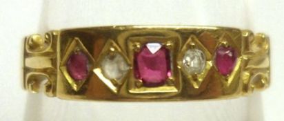 An early 20th Century hallmarked 18ct Gold Ring, a shaped front panel set with three small Rubies