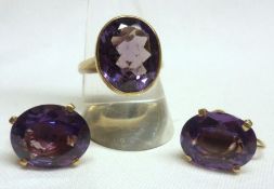 A yellow metal large single oval cut Amethyst Dress Ring; together with a pair of matching Screw