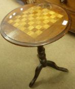 A late 19th Century Inlaid Pedestal Games Table, with round top to a stained beech column and tripod