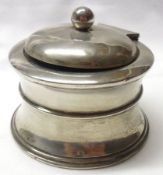 A George V Silver Encased Capstan Inkwell with raised body band, ceramic liner within, (the only