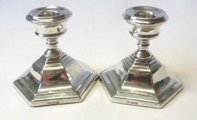A pair of Elizabeth II Silver Encased Dressing Table Candlesticks, with octagonal loaded bases,