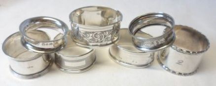 A Mixed Lot of seven assorted hallmarked Silver Napkin Rings, early 20th Century and later, weighing