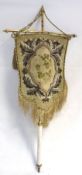 A Victorian Fabric and Metal Mounted Shield-shaped Face Screen with beaded needlework detail and