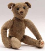 A small early 20th Century Straw-Filled Teddy Bear, possibly Steiff (although lacks button to