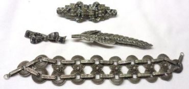 A packet containing a white metal filigree disc link Bracelet and three various Marcasite/paste
