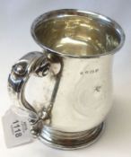 A George V Pint Tankard in Georgian style, of circular baluster form to a circular foot with leaf