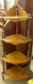 A Victorian Walnut Corner Whatnot of four tiered shelves held with turned supports, line inlaid