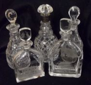 A pair of Glass Bottle-shaped Decanters, each with pear stoppers, facetted bodies (one repaired