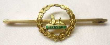 An early 20th Century mid-grade yellow metal Bar Brooch with centre garland surround panel of sphinx