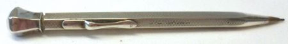 A mid-20th Century white metal encased Propelling Pencil, with engine turned panels, the clip