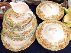 A Royal Doulton Part Dinner Service, decorated with the “Poppy” pattern, comprises a pair of