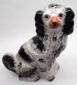 A 19th Century Staffordshire Large Model of a seated dog, black body markings, face with