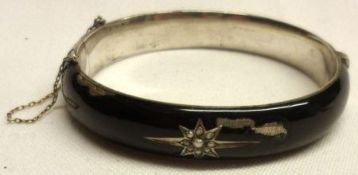 An Edwardian period white metal and black enamelled Bangle with Seed Pearl set star design to the