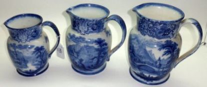 A Graduated Set of three Royal Doulton Geneva pattern blue and white Jugs, the largest 7” high (3)