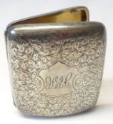 A late Victorian Cigarette Case of curved rectangular form, all over foliate engraved decoration,