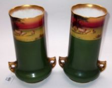 A pair of Royal Doulton Cylinder Vases, of spreading form, applied with gilded pierced handles and