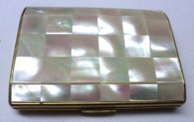 A mid-20th Century gilt metal and mother-of-pearl mounted Ladies Compact of facetted rectangular