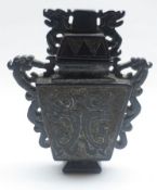 An Oriental Black Stone Covered Urn, of tapering rectangular form, applied on either side with