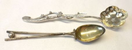A late 19th Century / early 20th Century Oriental white metal Sifting Spoon, with shaped and pierced
