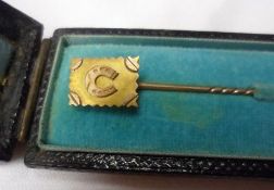 An unmarked yellow metal Stick Pin, the rectangular centre with raised horseshoe design, 70mm long