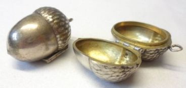 A pair of unusual white metal acorn-shaped Thimble Holders, each of two hinged parts, naturalistic