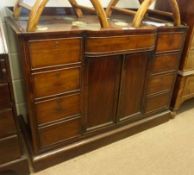 An early 19th Century Mahogany Sideboard, the top with raised edge and bowed central frieze drawer