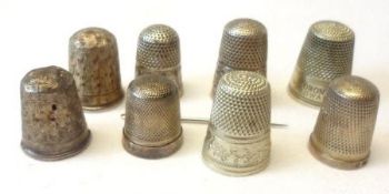 A collection of five hallmarked Silver Thimbles (conditions vary); a Sterling example and two