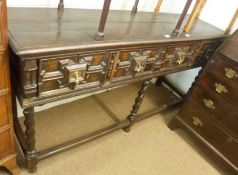 An Oak Dresser in Jacobean style, having three moulded panelled drawers to the frieze, top with