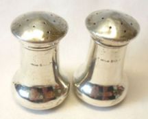 George V Baluster Peppers of plain design, 2 ½” tall, Birmingham 1930 (marks partially rubbed) (2)