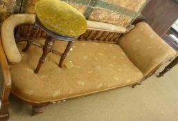 An Oak Chaise Longue, curved and galleried back, raised on ring-turned spindles and on fluted and