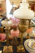 An early 20th Century Brass Oil Lamp on square base with opaque glass font and clear glass funnel,