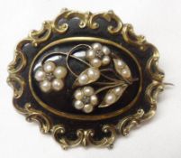 A Victorian Gold Framed Mourning Brooch of shaped oval form, the black enamelled centre featuring
