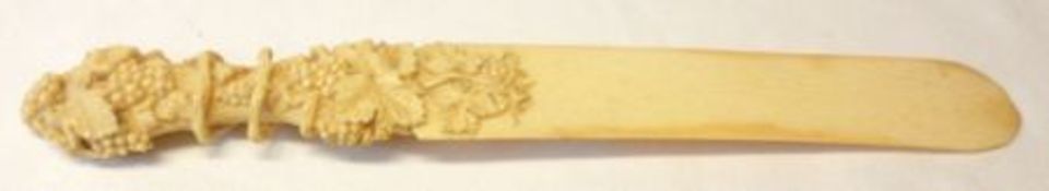 A Victorian Carved Ivory Paperknife with plain blade (minor losses at end) and with grapevine carved