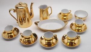 A Royal Worcester Fireproof Gold Lustre Coffee Set, comprises six Cups and Saucers, Cream Jug and