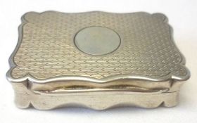An early 20th Century Snuff Box, of shaped rectangular design, engine-turned lid and base, gilt-