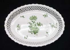 An oval Dish with pierced latticed border and the centre decorated in green with floral sprigs and