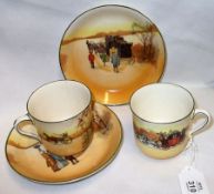 A pair of Royal Doulton Series Ware Cups and Saucers, each decorated in colours with coaching