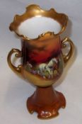 A Royal Doulton Two-Handled Vase of circular baluster form, with gilded rim, handles and foot,