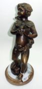 A 20th Century Bronze Patinated Figure of a Putto clutching a large insect, 15” high