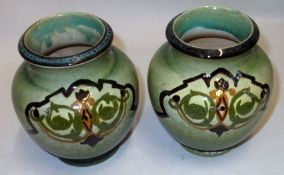 A pair of English Pottery Baluster Vases, decorated in green, ochre and black on a speckled green