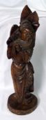 An Oriental Hardwood Carved Figure inset with garnet stone decoration, 16” high