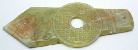 An Oriental Jade Small Panel formed as a pointer or arrow with a wheel decorated centre, 20th