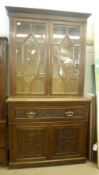 A late Victorian Oak Secretaire Cabinet, the top section with two astragal glazed doors with