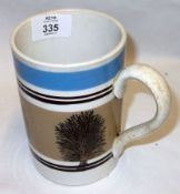 A Mocha Ware Tankard, decorated in blue and treacle and with motifs of trees, 5” high