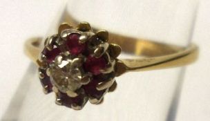 A hallmarked 18ct Gold centre small Diamond and small Ruby surround Cluster Ring