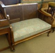 An early 20th Century Mahogany Cottage style Bergère Sofa with single cane back and sides, plain