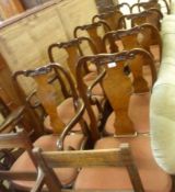 A set of ten Queen Anne style Walnut and Mahogany Dining Chairs, all with scroll moulded cresting