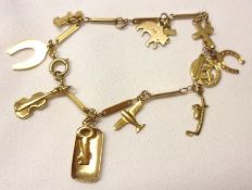 An early/mid-20th Century yellow metal Lightweight Charm Bracelet, hung with numerous small