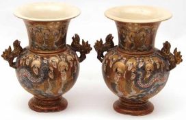 A pair of Satsuma Two-Handled Baluster Vases, painted in colours with panels of immortals and