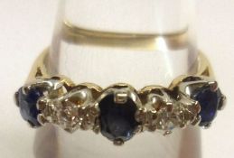 A high grade precious metal three Mid-Blue Sapphire and two small brilliant cut Diamond Ring,